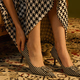 Elegant-houndstooth-pumps-crafted-from-tweed_-featuring-stunning-embellishments-for-a-refined-and-glamorous-look