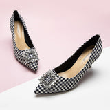 Elegant-houndstooth-pumps-crafted-from-tweed_-featuring-stunning-embellishments-for-a-refined-and-glamorous-look