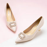 Elegant-white-pumps-crafted-from-leather_-featuring-stunning-embellishments-for-a-refined-and-glamorous-look