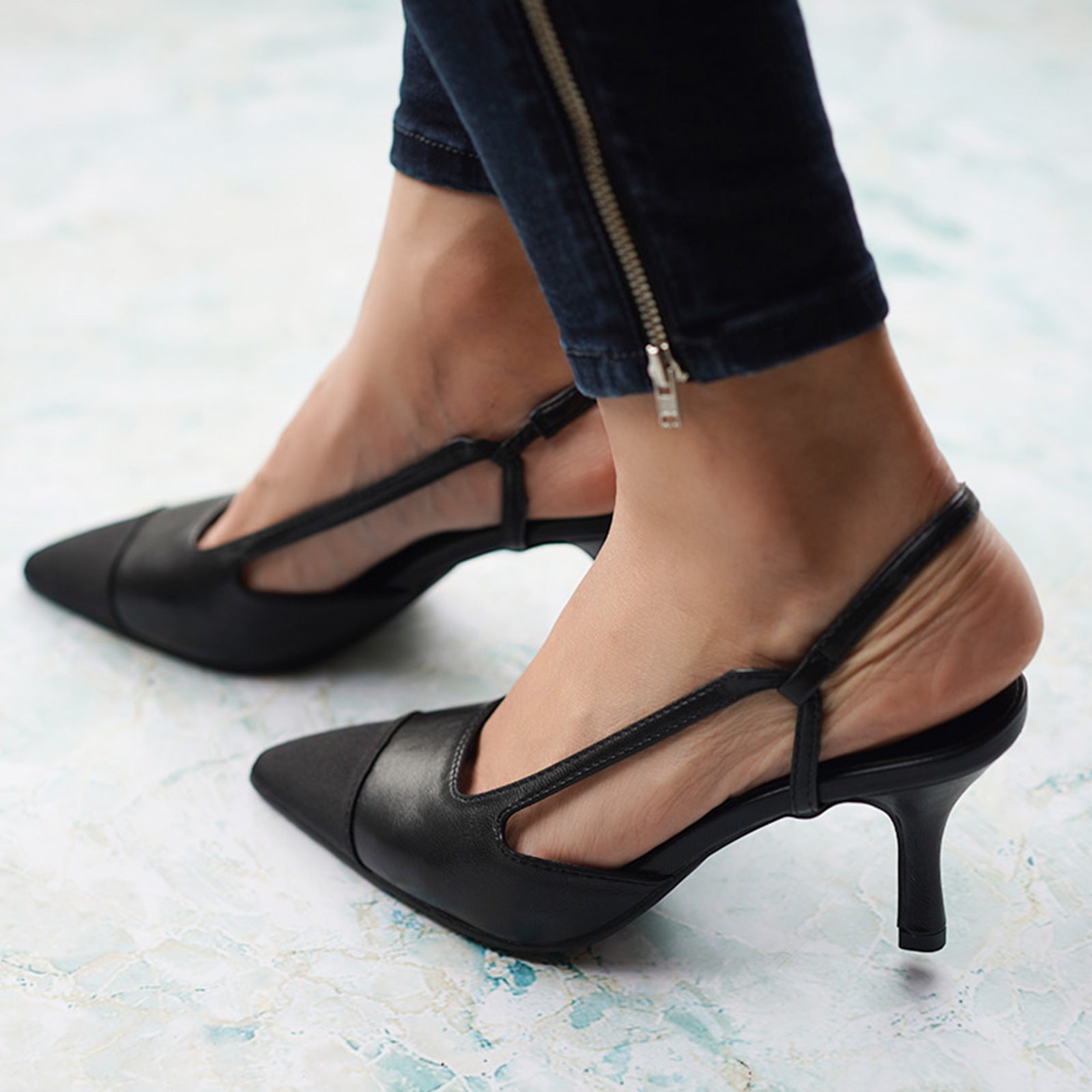  Black Slingback Pumps with a pointed toe, a modern and edgy option for city living with a touch of sophistication