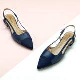 Navy Slingback Flats with a pointed toe, perfect for a confident and fashionable look in any urban setting.
