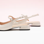 White Squared Toe Slingback Flats, perfect for a confident and fashionable look in any urban setting.