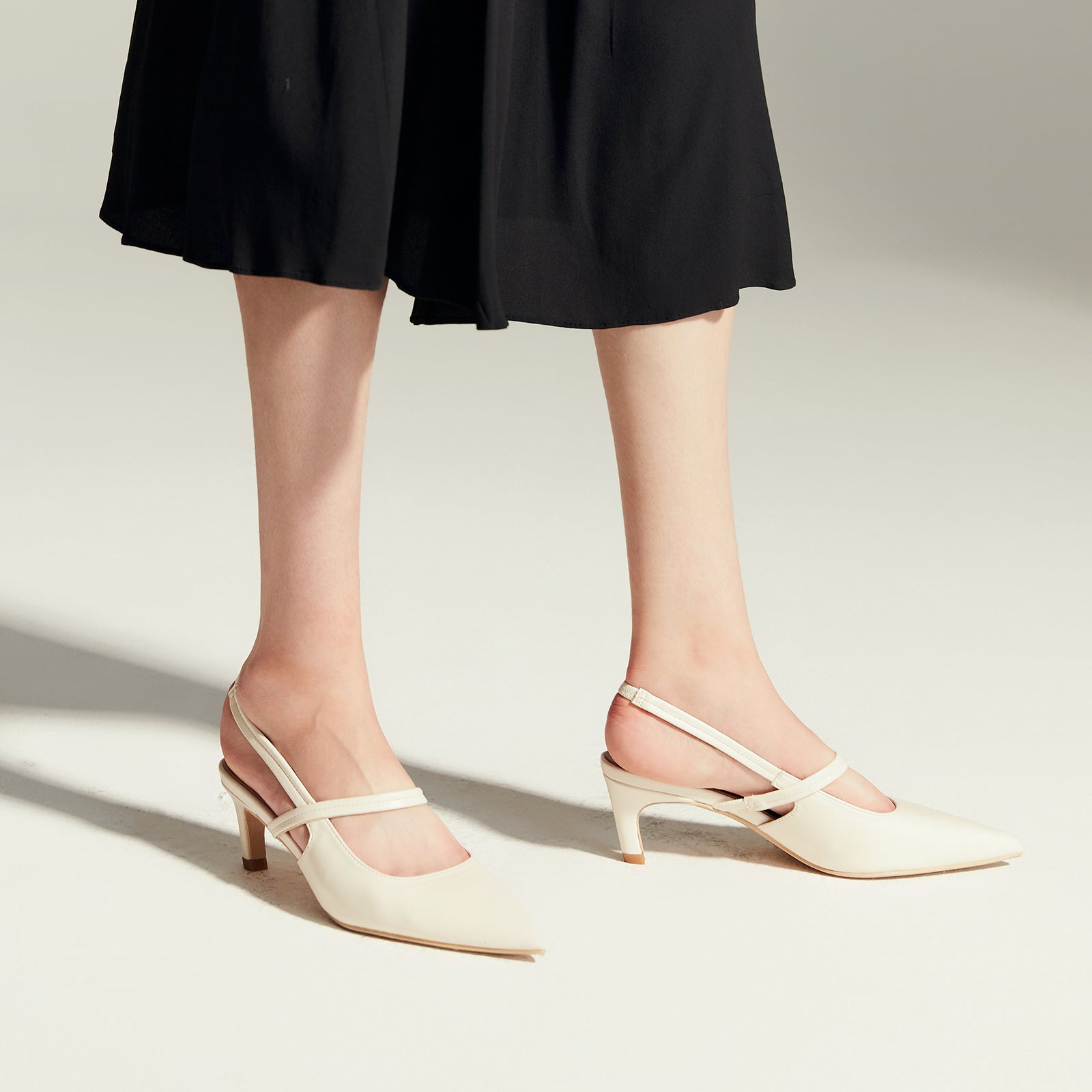 White Strappy Slingback Pumps with a pointed toe, combining comfort with a touch of timeless elegance