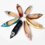 Chic and elegant black leather flats featuring tasteful adornments.