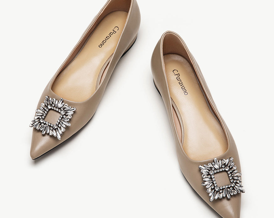 Camel leather flats adorned with stylish embellishments for a touch of elegance.
