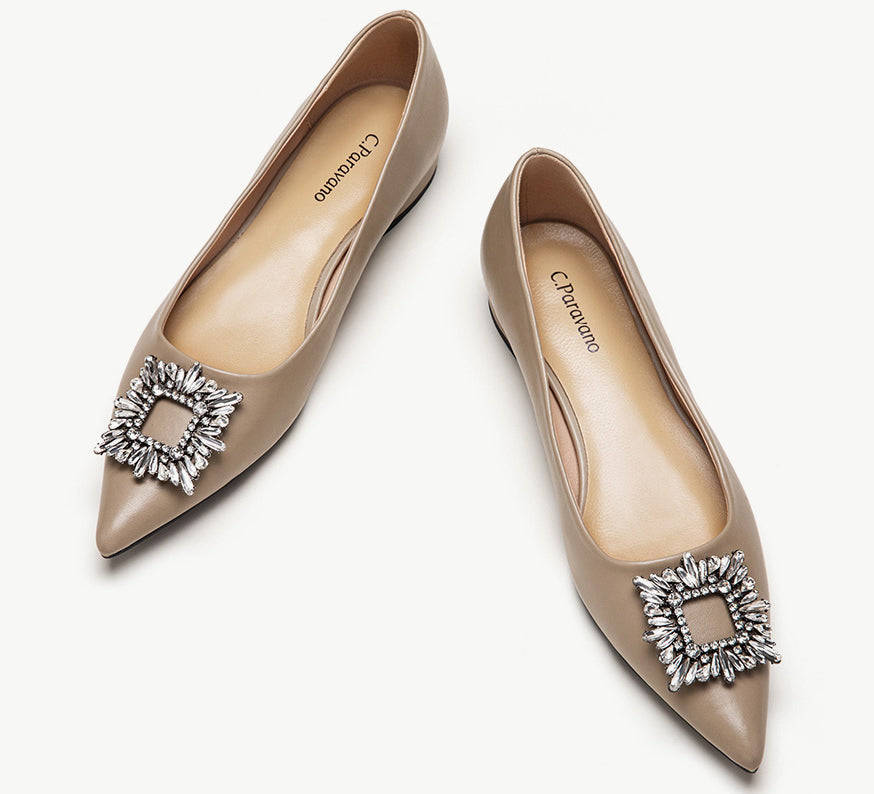 Camel leather flats adorned with stylish embellishments for a touch of elegance.