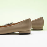Classic camel leather flats featuring decorative details.