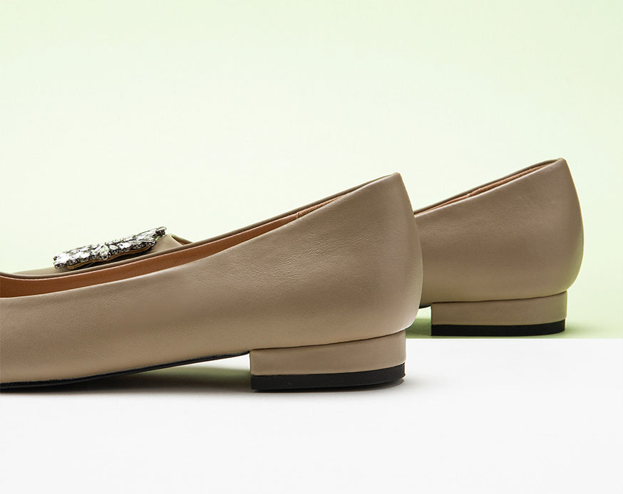 Classic camel leather flats featuring decorative details.
