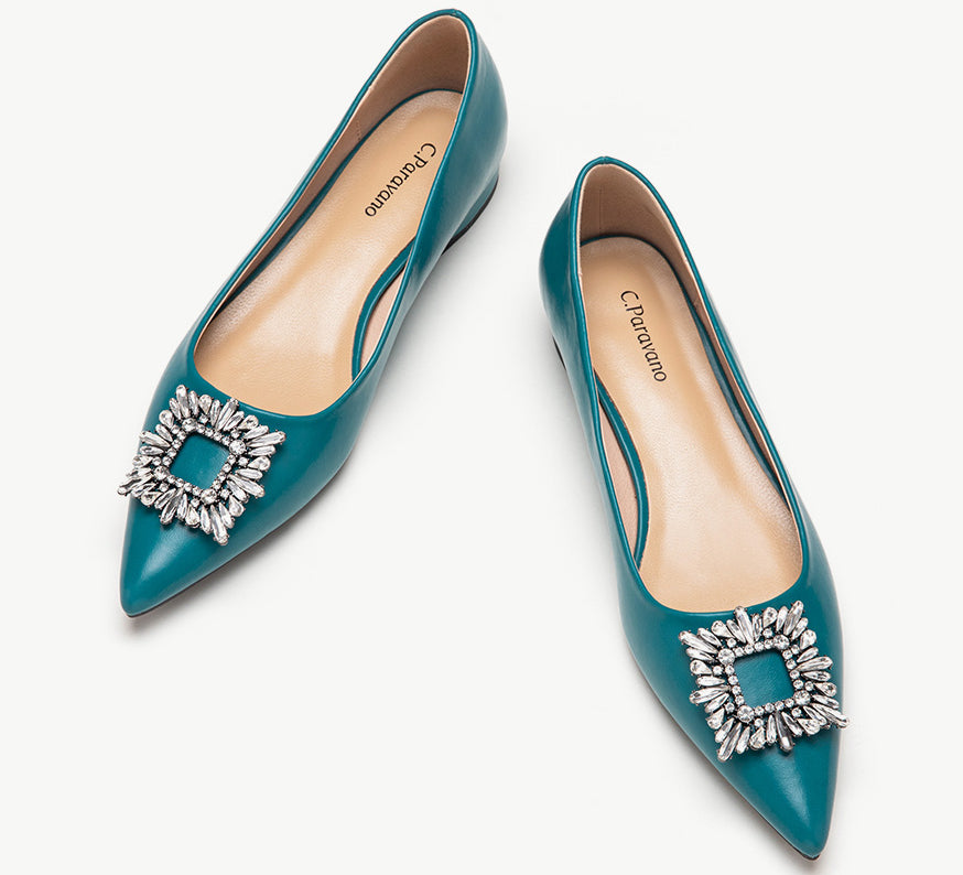 Peacock blue leather flats adorned with stylish embellishments for an elegant look.