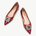 Red leather flats adorned with stylish embellishments for a touch of elegance