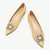 Yellow leather flats adorned with stylish embellishments for a touch of elegance