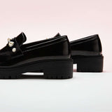 Black Pearl Platform Loafers, perfect for a confident and fashionable look in any urban setting.