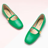 Green Mary Janes with a single stripe button, perfect for a confident and fashionable look in any urban setting