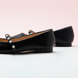 Black Mary Jane Flats with a single stripe and pearl detail, a modern and stylish option for urban chic.