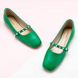 Green Mary Jane Flats with a single stripe and pearl detail, perfect for a confident and fashionable look in any urban setting