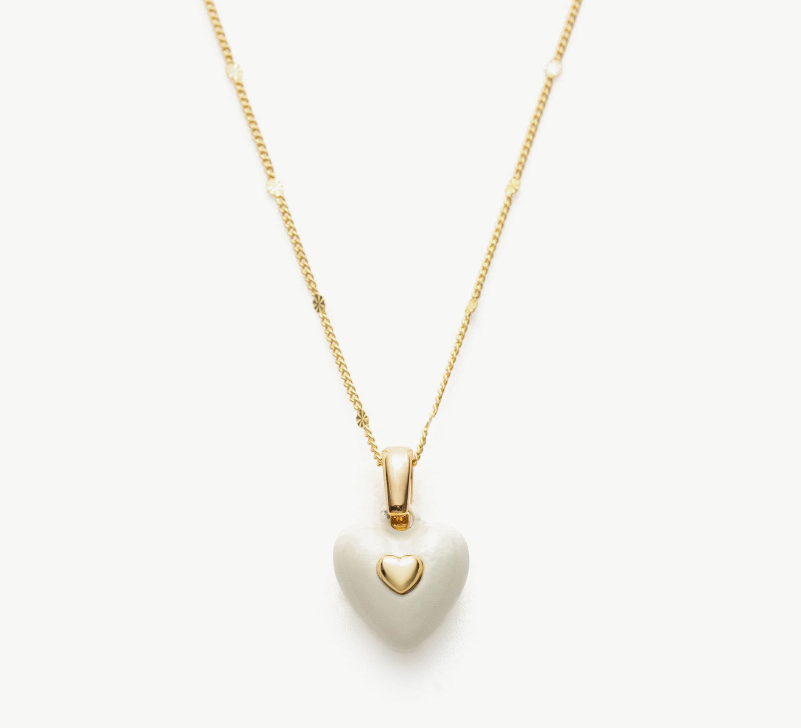 Onyx Heart Pendant Necklace in White, symbolizing opulent white beauty, this necklace features a captivating heart-shaped onyx pendant suspended from a delicate chain.