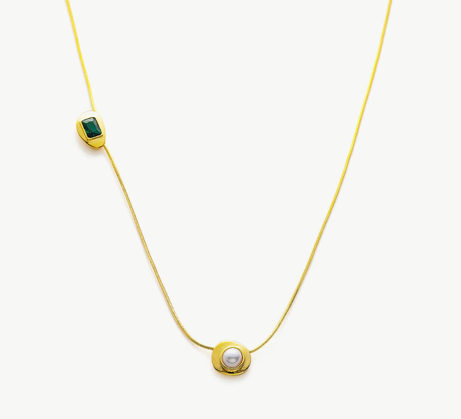 Gold Crystal Drop Necklace with a captivating emerald crystal pendant, showcasing an elegant and radiant design on a golden chain, adding a touch of glamour and sophistication to your ensemble.