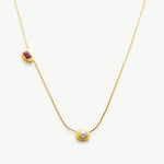 Gold Crystal Drop Necklace with a captivating ruby crystal pendant, showcasing a radiant and elegant design on a golden chain, adding a touch of glamour and sophistication to your ensemble.