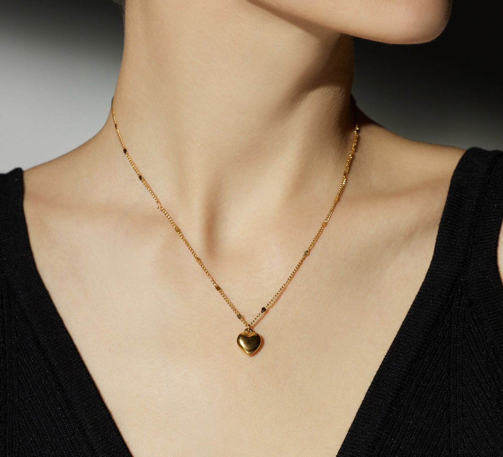Gold Heart Pendant Necklace, a chic gold accent that enhances your style, featuring a stylish heart-shaped pendant in a lustrous gold hue.