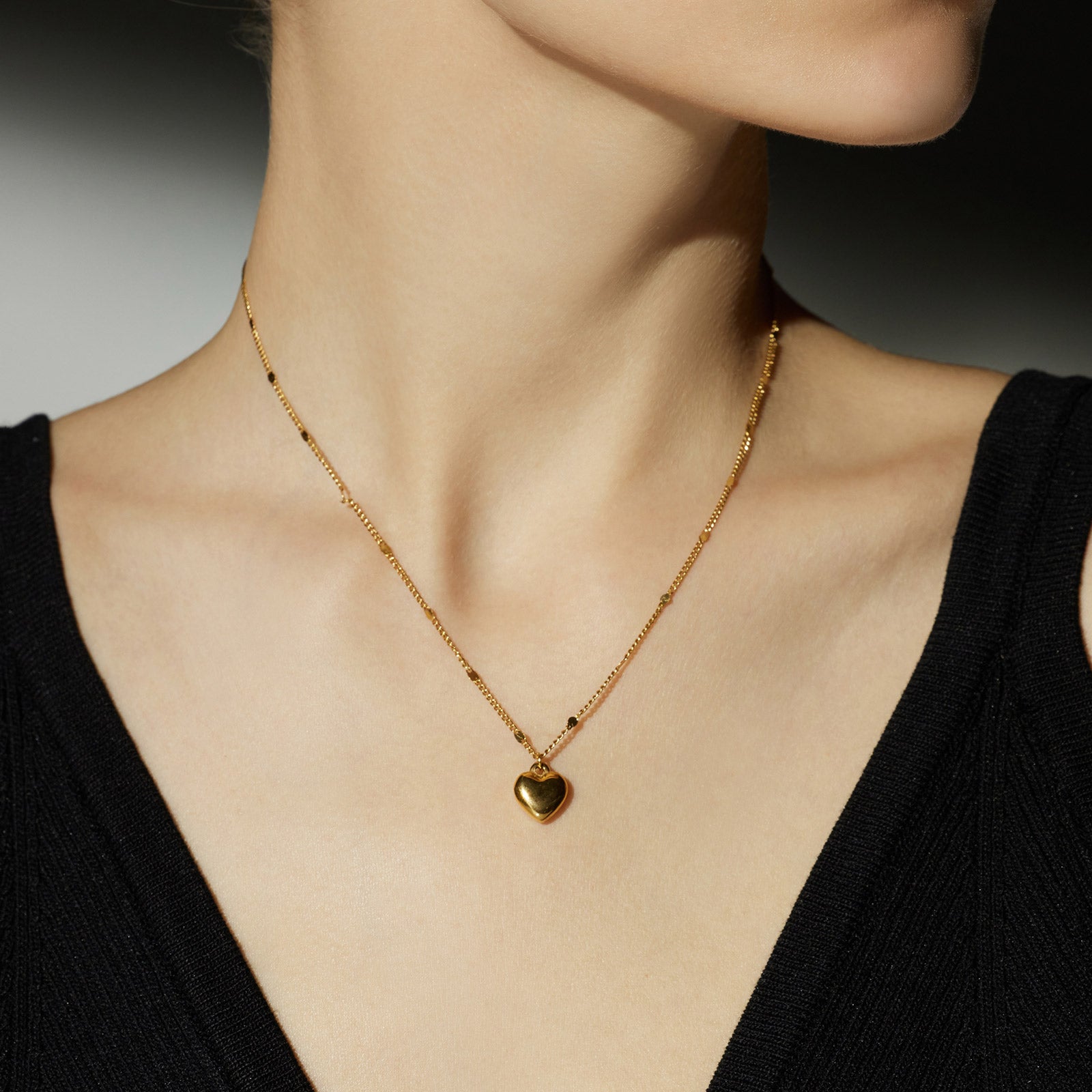 Gold Heart Pendant Necklace, a chic gold accent that enhances your style, featuring a stylish heart-shaped pendant in a lustrous gold hue.