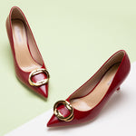 A pair of striking red oval chic buckled pumps, a fashionable choice.