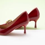 Red women's shoes with an oval chic buckle, ideal for a classy look.