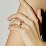 Crossover Ring adorned with crystals in radiant gold, a chic and eye-catching addition to your jewelry collection