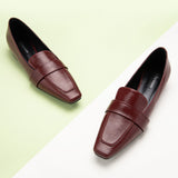 Stylish red loafers - in an urban setting.
