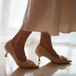 Sleek-and-timeless-white-C-buckled-pumps_-exuding-a-sense-of-elegance-and-versatility