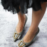 Stylish-green-pumps-with-buckle-detailing_-offering-a-trendy-and-fashionable-choice-for-footwear