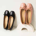 Stylish-pink-ballet-flats-enhanced-with-a-graceful-bowknot-embellishment-for-a-fashionable-look.