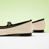 Stylish-white-ballet-flats-with-a-charming-bowknot-detail-and-a-luxurious-suede-toe.