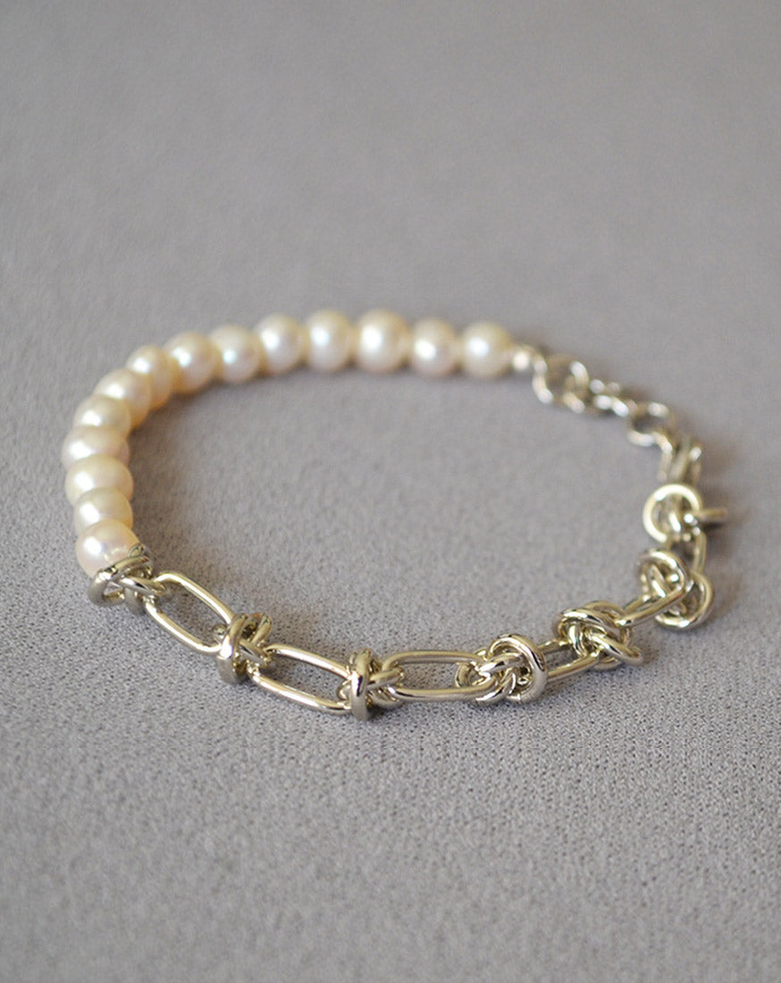 Molten Baroque Pearl Twisted Chain Bracelet, coiled with a touch of platinum luxury, this bracelet adds a hint of glamour and sophistication to your wrist, making it perfect for special occasions