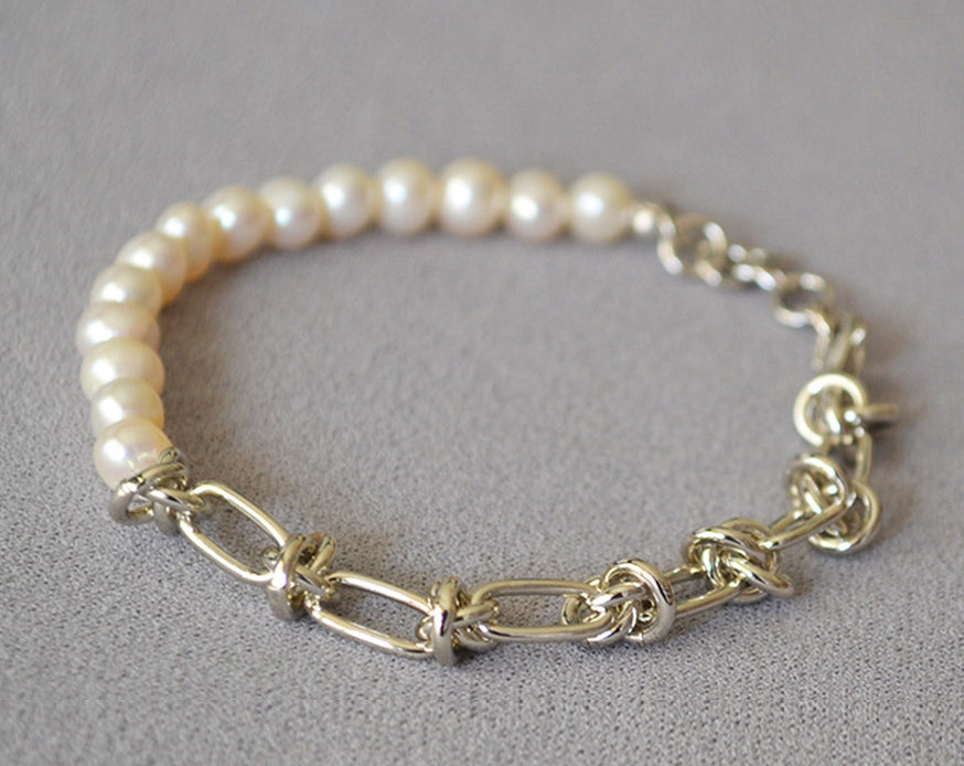 Molten Baroque Pearl Twisted Chain Bracelet, coiled with a touch of platinum luxury, this bracelet adds a hint of glamour and sophistication to your wrist, making it perfect for special occasions