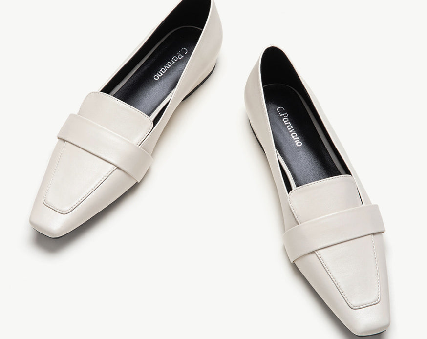 White platform loafers with penny strap detail.