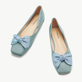 A pair of trendy blue bowknot square flats, perfect for stylish comfort.