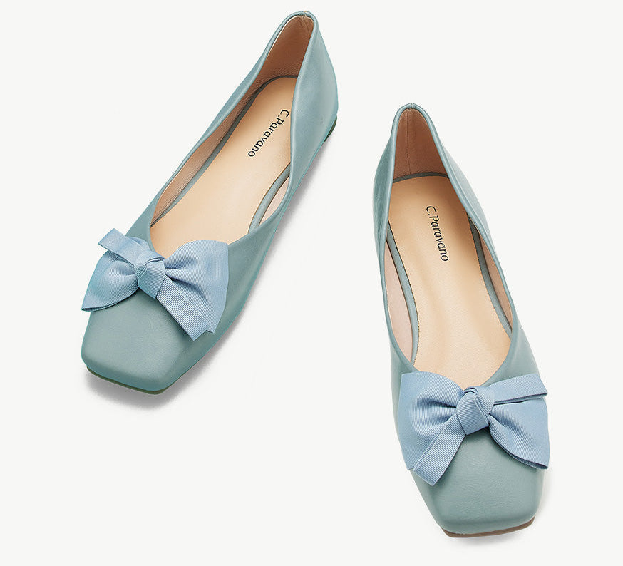 A pair of trendy blue bowknot square flats, perfect for stylish comfort.