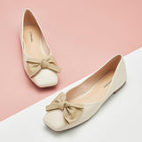 white square flats with a metallic bowknot detail - a chic and trendy choice.