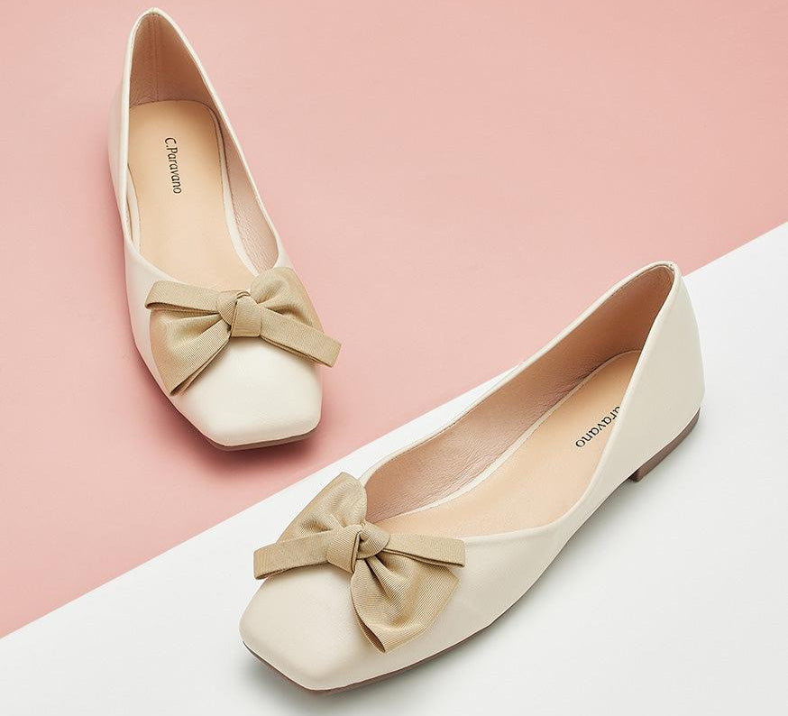 white square flats with a metallic bowknot detail - a chic and trendy choice.