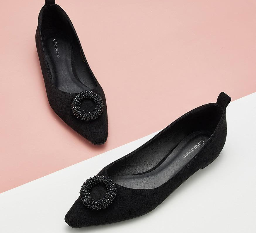 Classic black suede flats with a pointed toe design.