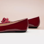 Classic red Patent Leather Flats with a pointed toe, offering timeless style.