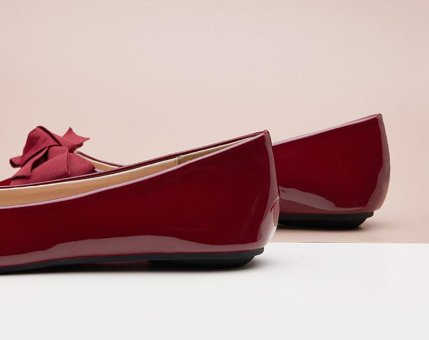 Classic red Patent Leather Flats with a pointed toe, offering timeless style.
