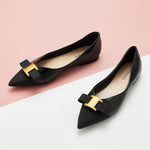Classic black flats in genuine leather with tasteful adornments