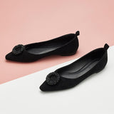 Step out in sophistication with black point-toe suede flats.