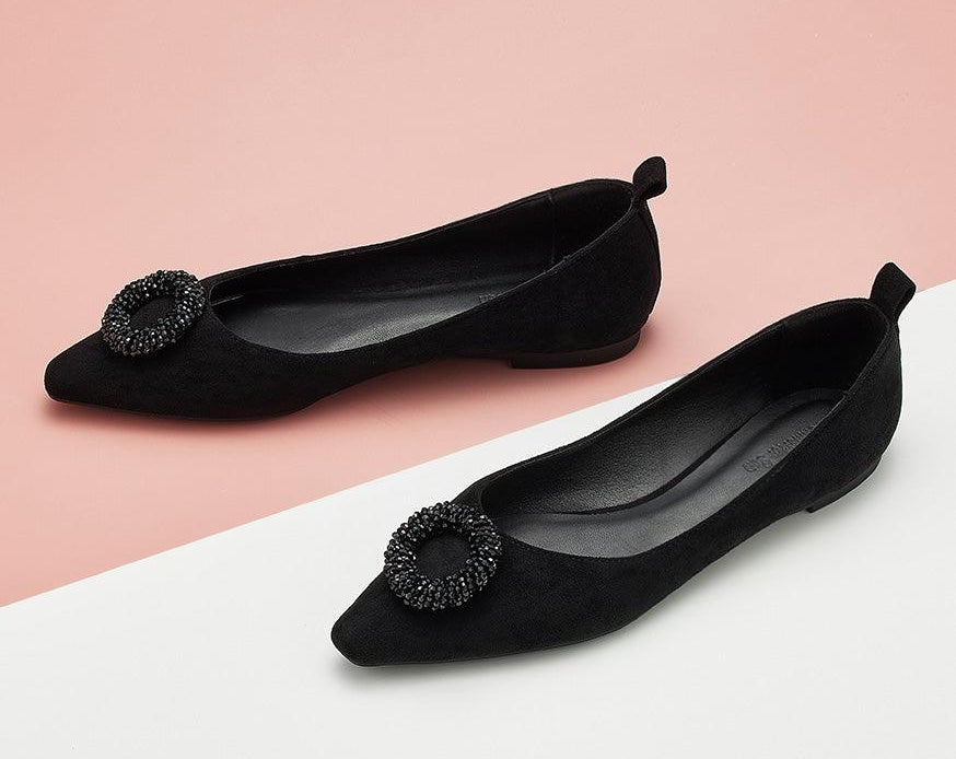 Step out in sophistication with black point-toe suede flats.