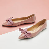 Stylish pink Patent Leather Flats with a pointed toe, a symbol of sophistication.