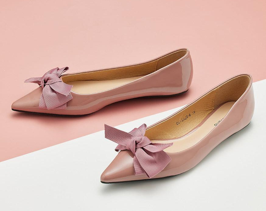 Stylish pink Patent Leather Flats with a pointed toe, a symbol of sophistication.