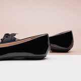 Classic black Patent Leather Flats with a pointed toe, exuding refined style.