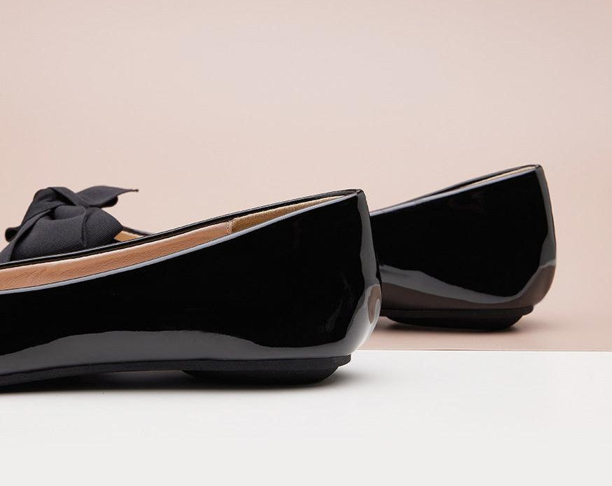 Classic black Patent Leather Flats with a pointed toe, exuding refined style.