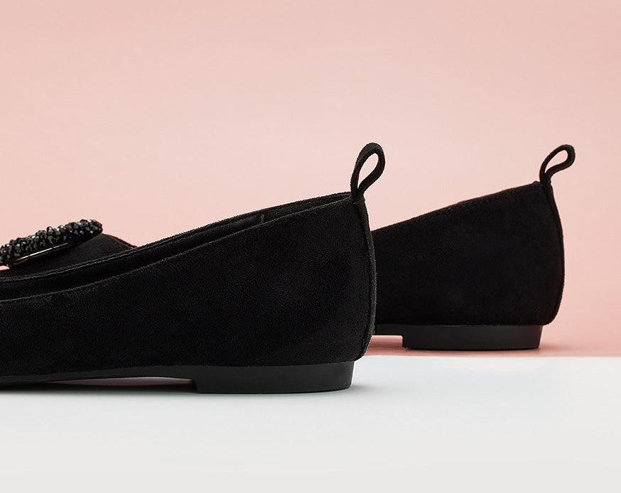 Classic black suede flats with a pointed toe design